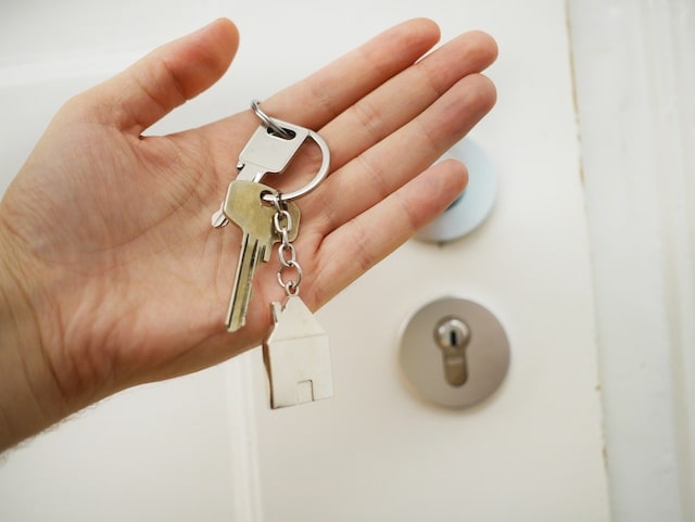 Keys on a hand in front of a door for Concord property tax