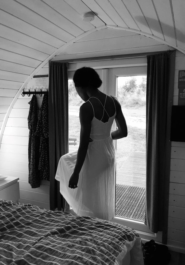 Woman inside a tiny house in monochrome for are tiny homes legal in California