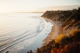 beautiful-shot-people-walking-wild-seashore-californian-hills